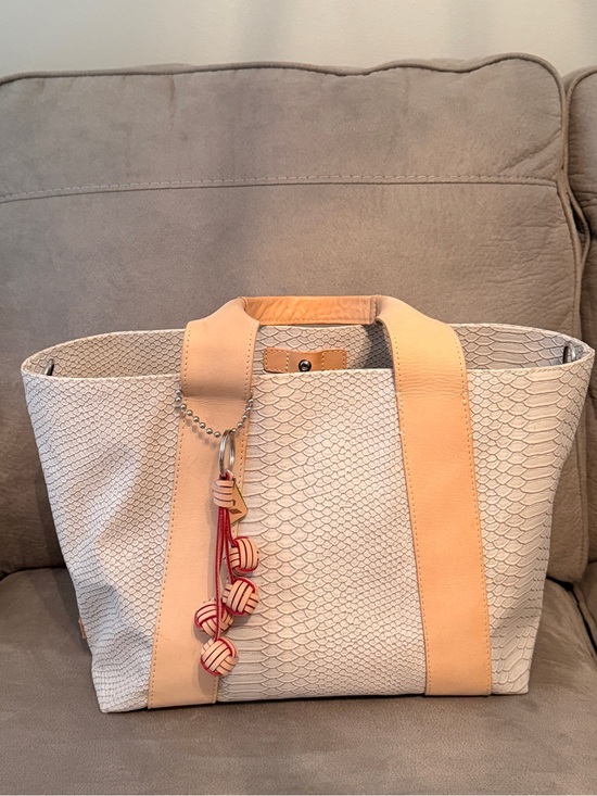 Consuela Handbags - Consuela Thunderbird Carryall Cream Textured Tote with Tan Straps and Red Tassel
